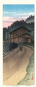 Hasui: Dusk at Nenoyama. An elder man laden with kindling patiently takes to the road, walking stick in hand. WIth the limited edition seal, verso.