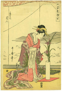 Utamaro: Kneeling beauty arranging flowers